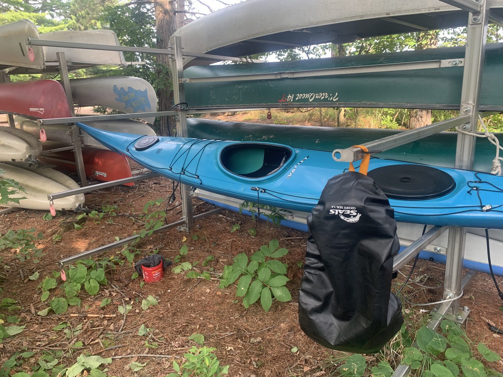 The kayak rack lineup at Big Bay Town Park with numbered tags