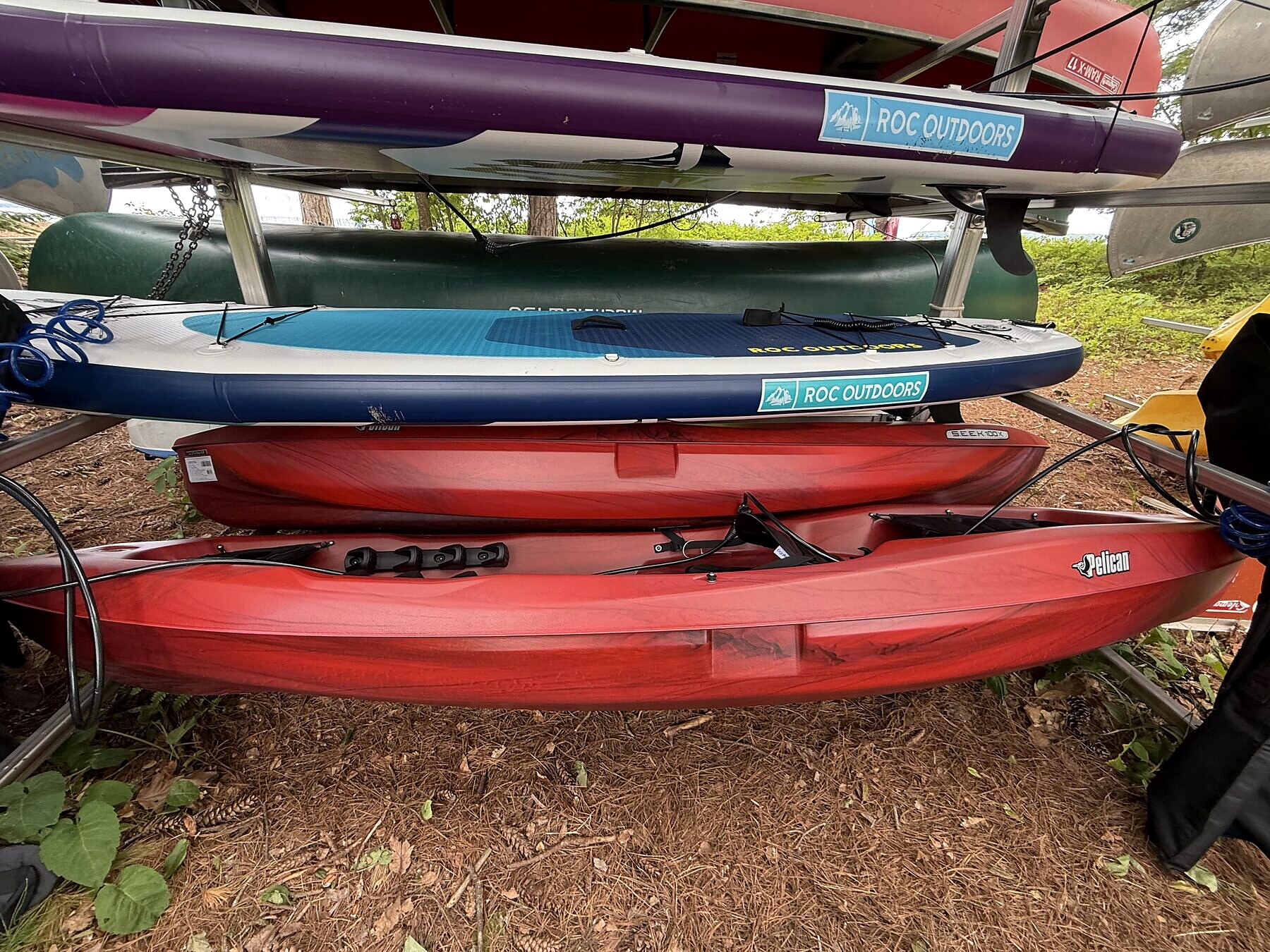 Close-up of kayaks and paddleboards stored on the rack